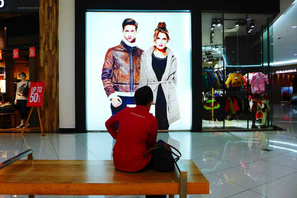 A person looking at an LED advertisement screen